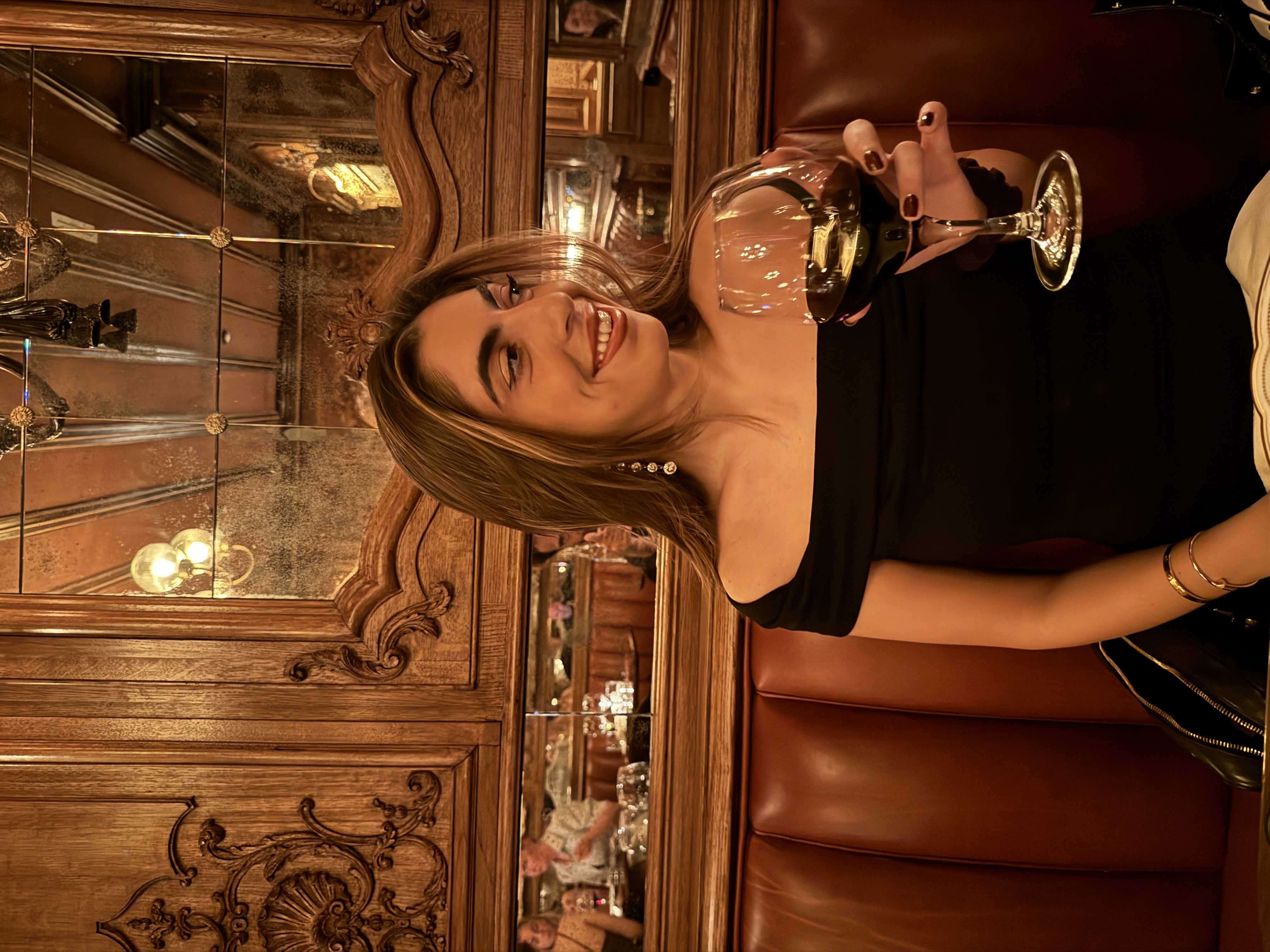 Sarvi holding a glass of red wine